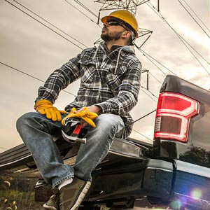 worker sitting on vehicle